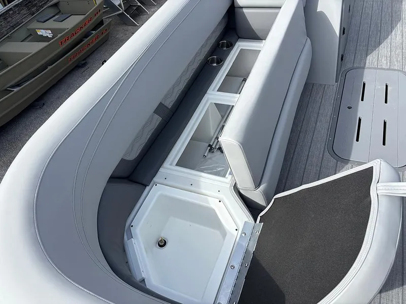 Slide: The Image of 2025 SunCatcher Fusion 324RC boat interior with storage compartments and seating. - 15