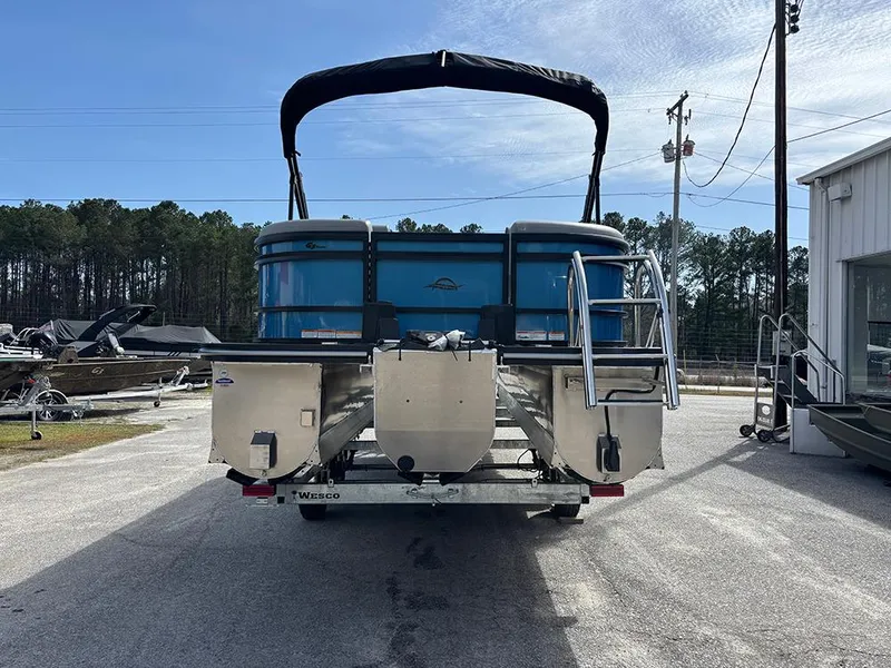 Slide: The Image of 2025 SunCatcher Fusion 324RC pontoon boat, rear view, parked outdoors. - 8