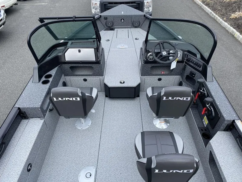 Slide: The Image of 2025 Lund 1875 Impact XS Sport boat interior with seating and steering console. - 12