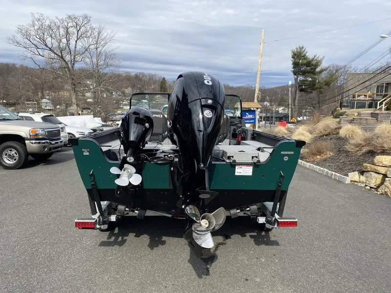 Slide: The Image of 2025 Lund 1875 Impact XS Sport boat with dual outboard motors on a trailer. - 4