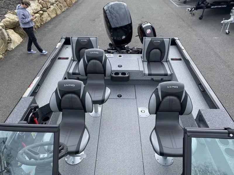 Slide: The Image of 2025 Lund 1875 Impact XS Sport boat interior with four seats and motor. - 7