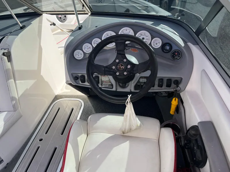 Slide: The Image of 1999 MasterCraft XStar boat dashboard with steering wheel and gauges. - 4