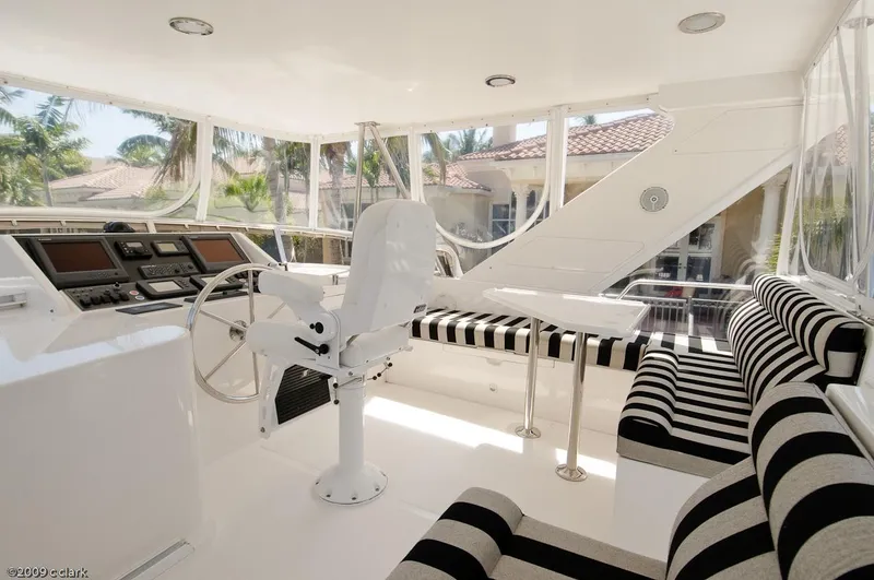 Slide: The Image of 2005 Ocean Alexander 58 Motoryacht interior with striped seating and helm station. - 13