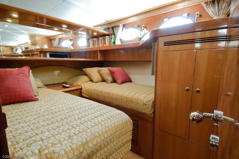 Slide: The Image of Luxurious 2005 Ocean Alexander 58 Motoryacht cabin with elegant wood finishes and cozy bedding. - 7