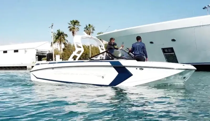 The Image of 2020 Nautique Super Air G23 boat on water, with two people onboard. - 0