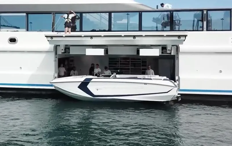 Slide: The Image of 2020 Nautique Super Air G23 being launched from a yacht garage. - 1