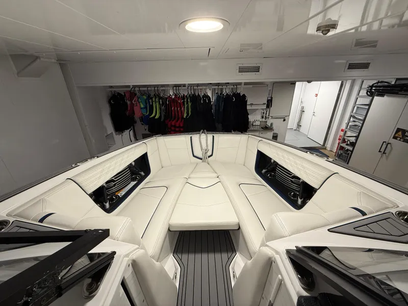 Slide: The Image of 2020 Nautique Super Air G23 boat interior with white seating and storage area. - 10