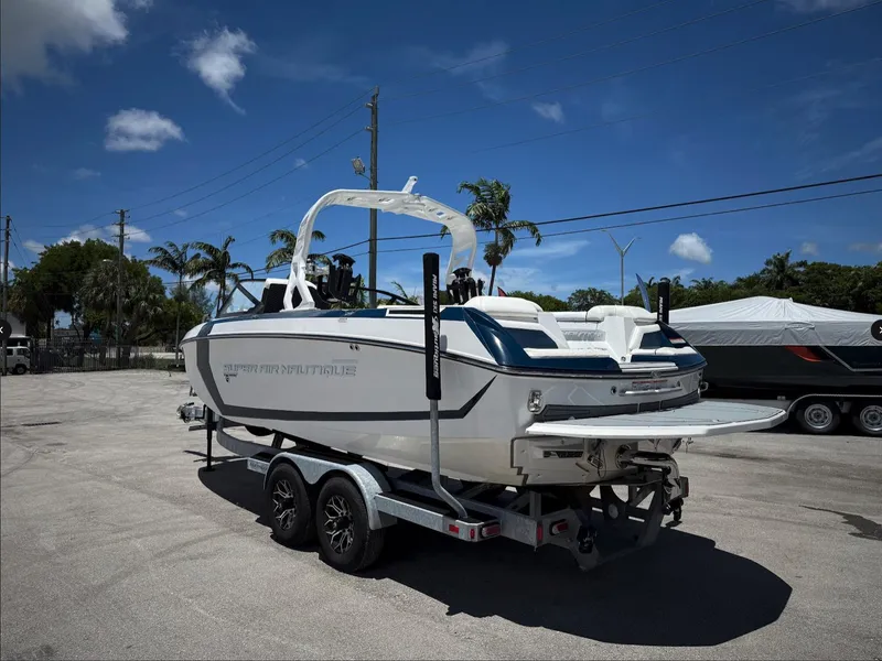 Slide: The Image of 2020 Nautique Super Air Nautique G23 boat on trailer under clear blue sky. - 15