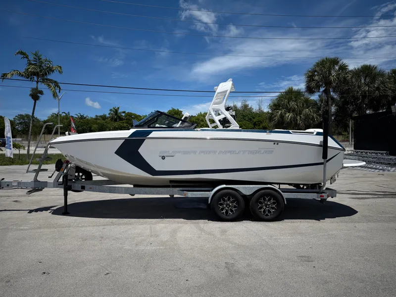 Slide: The Image of 2020 Nautique Super Air Nautique G23 boat on trailer, parked outdoors. - 17