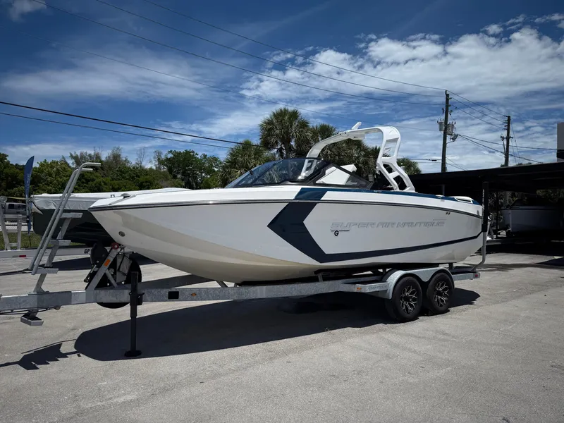Slide: The Image of 2020 Nautique Super Air Nautique G23 boat on trailer under blue sky. - 19