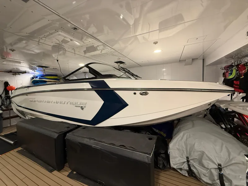 Slide: The Image of 2020 Nautique Super Air G23 boat stored indoors, showcasing sleek design and modern features. - 5