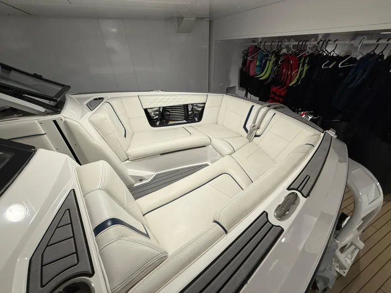 Slide: The Image of 2020 Nautique Super Air G23 boat interior with white seating and storage area. - 6