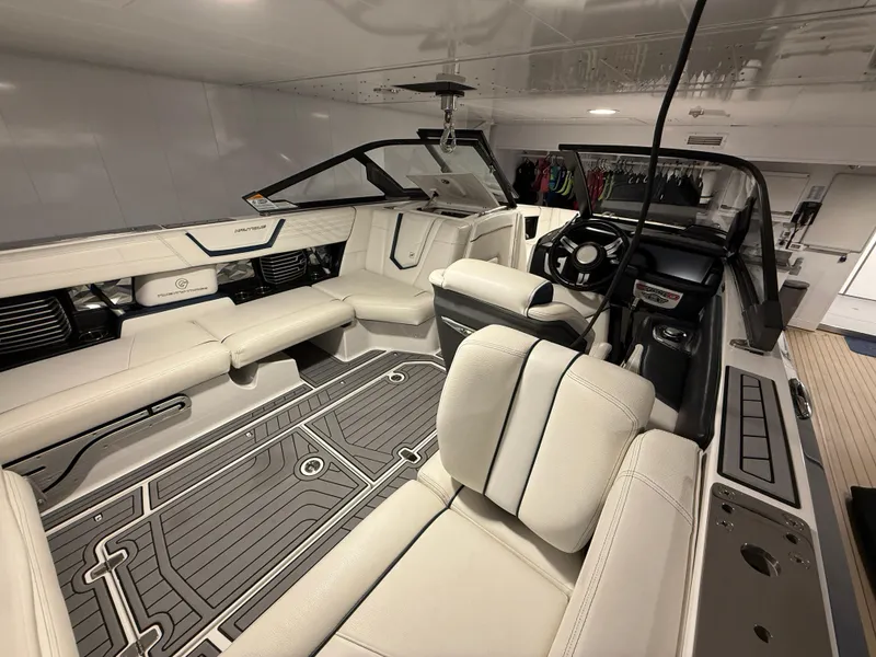 Slide: The Image of 2020 Nautique Super Air G23 boat interior with luxurious seating and modern dashboard. - 9