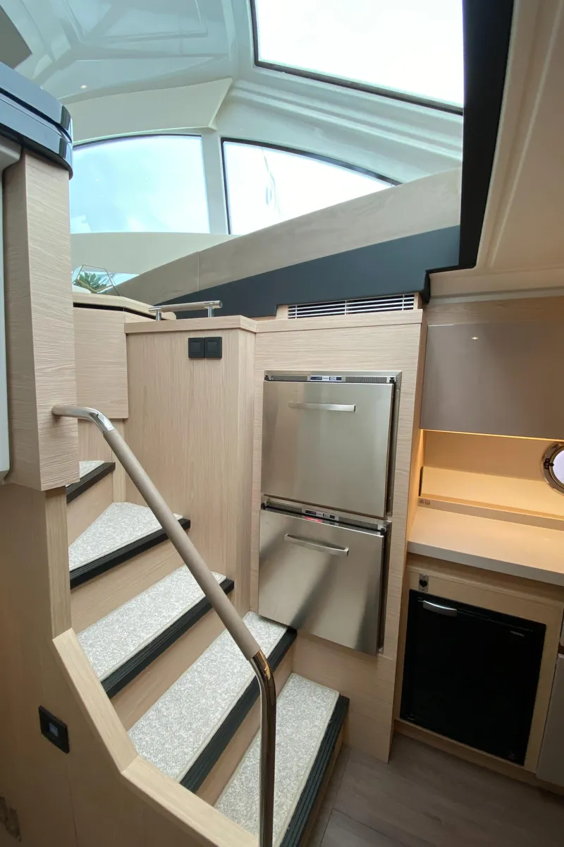 Slide: The Image of Interior of 2020 Beneteau Gran Turismo 50 Sportfly yacht with modern kitchen and stairs. - 11
