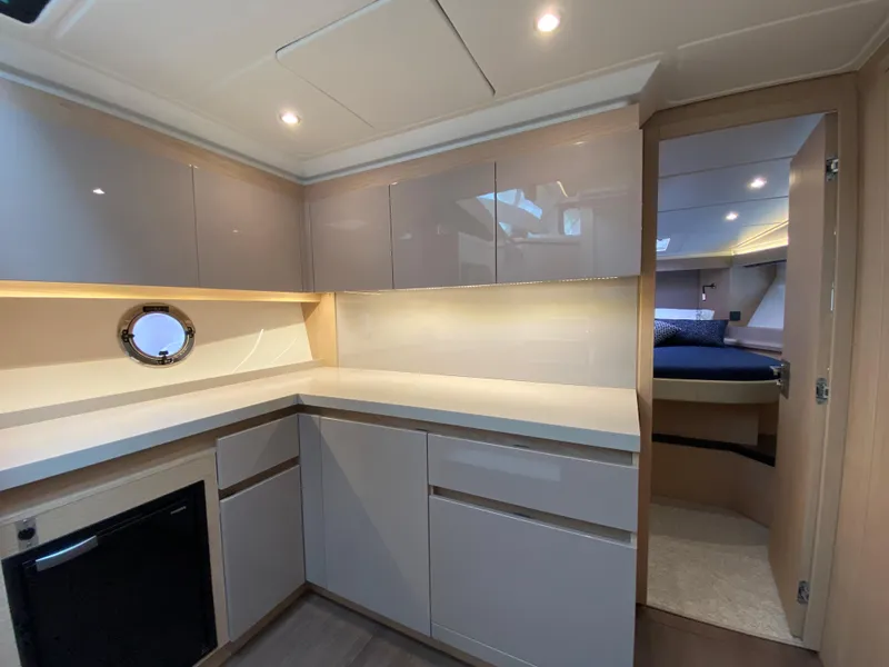 Slide: The Image of 2020 Beneteau Gran Turismo 50 Sportfly yacht interior with modern kitchen and cozy bedroom. - 15