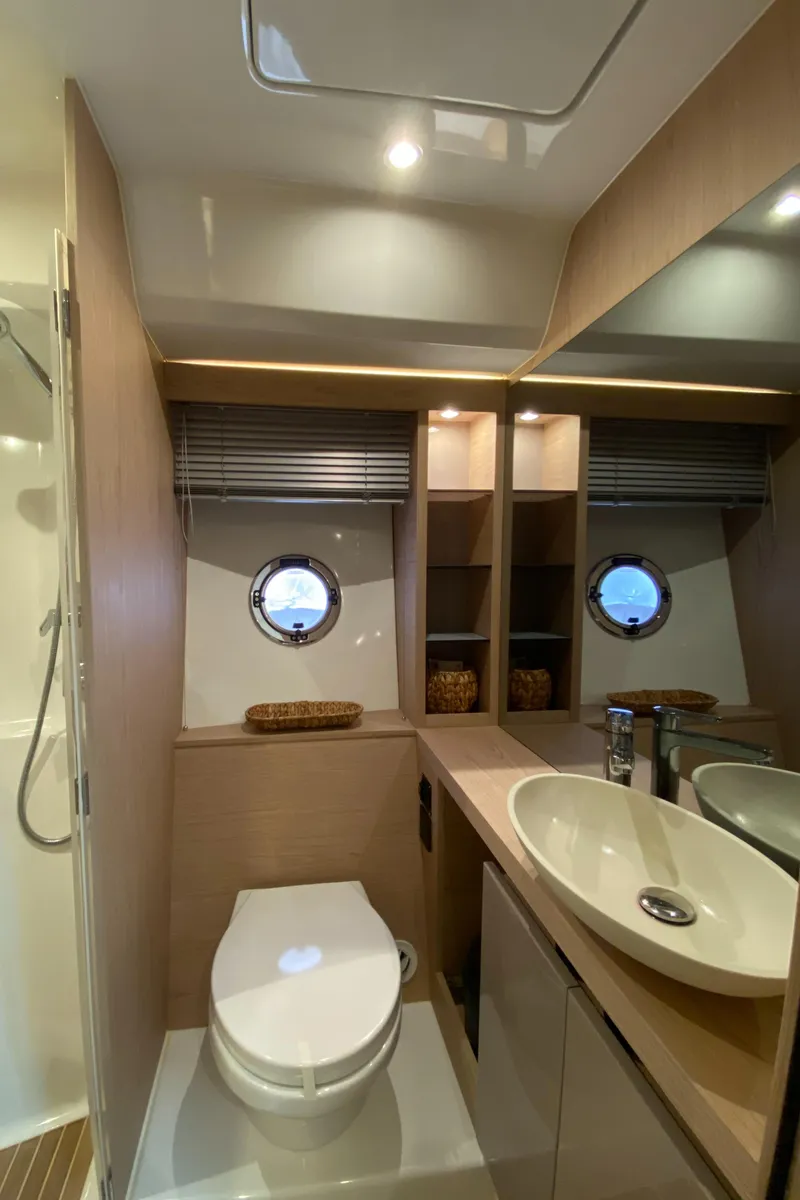 Slide: The Image of Modern bathroom in 2020 Beneteau Gran Turismo 50 Sportfly yacht, featuring sleek design and porthole window. - 16