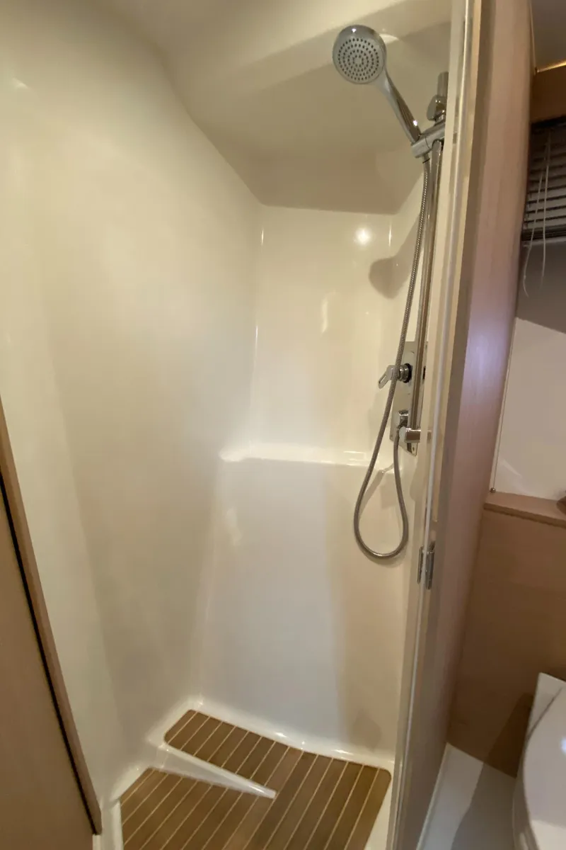 Slide: The Image of 2020 Beneteau Gran Turismo 50 Sportfly shower with modern fixtures and wooden flooring. - 17
