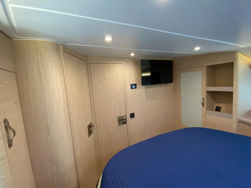 Slide: The Image of Interior cabin of 2020 Beneteau Gran Turismo 50 Sportfly with modern wood finish and TV. - 22
