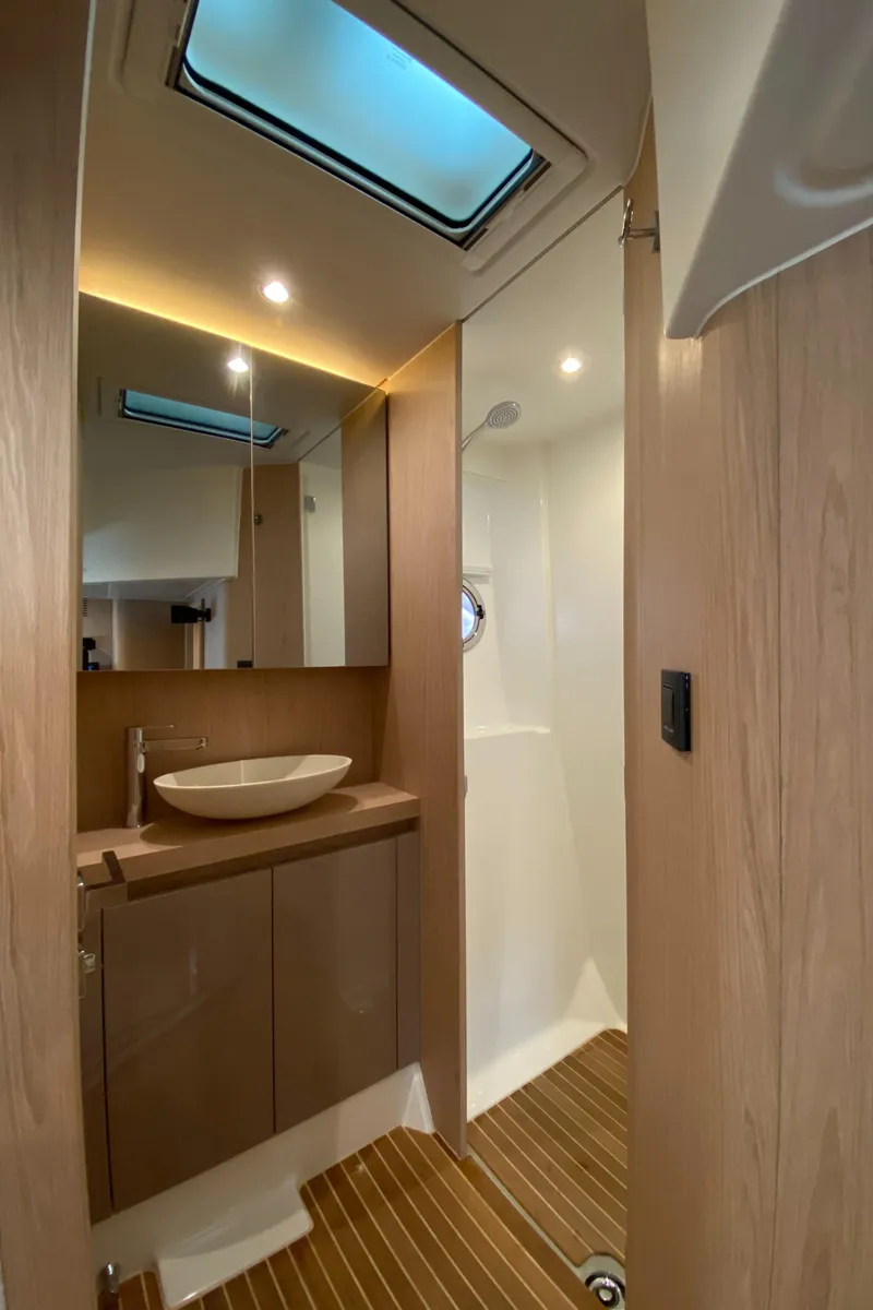 Slide: The Image of 2020 Beneteau Gran Turismo 50 Sportfly bathroom with modern fixtures and wood accents. - 35