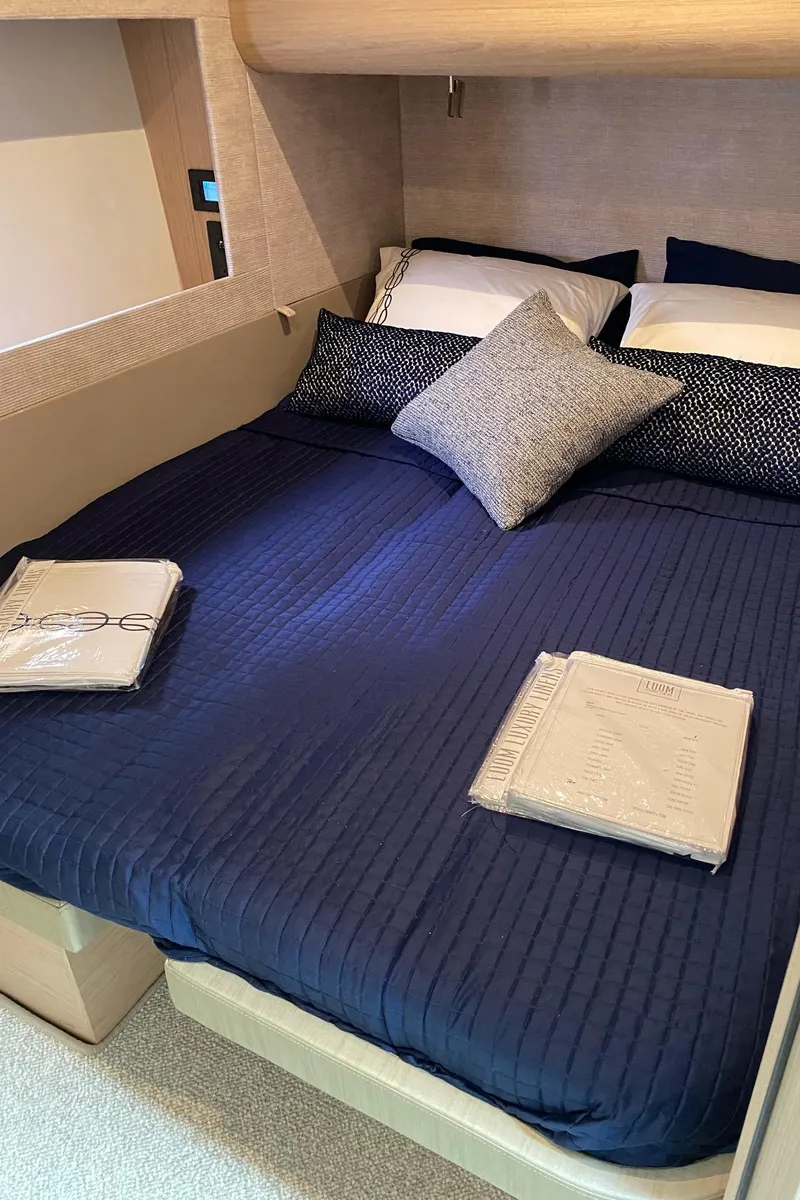 Slide: The Image of 2020 Beneteau Gran Turismo 50 Sportfly cabin with navy bedding and modern decor. - 39