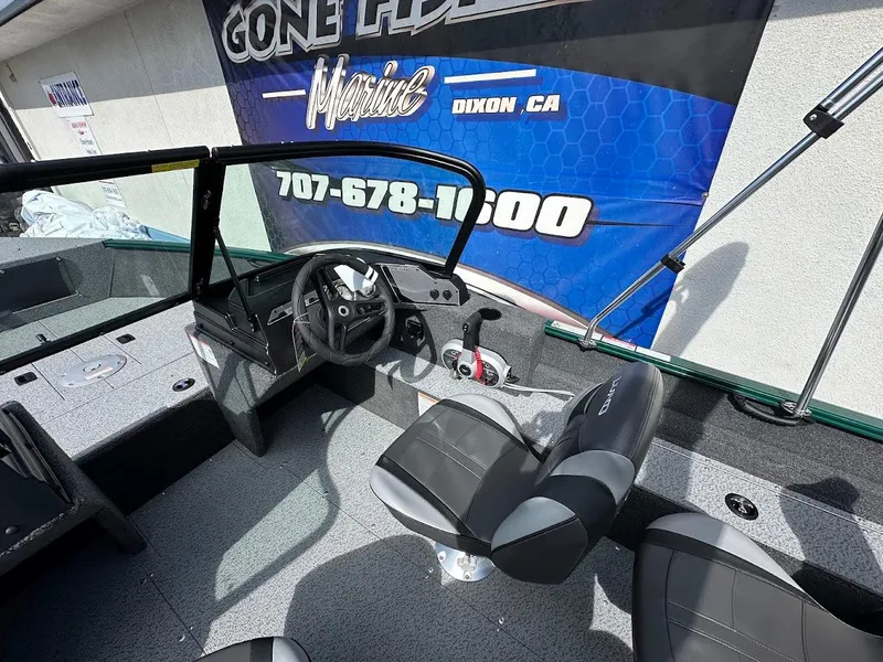 Slide: The Image of 2025 Lund 1650 Rebel XL Sport boat interior with steering wheel and seating. - 14