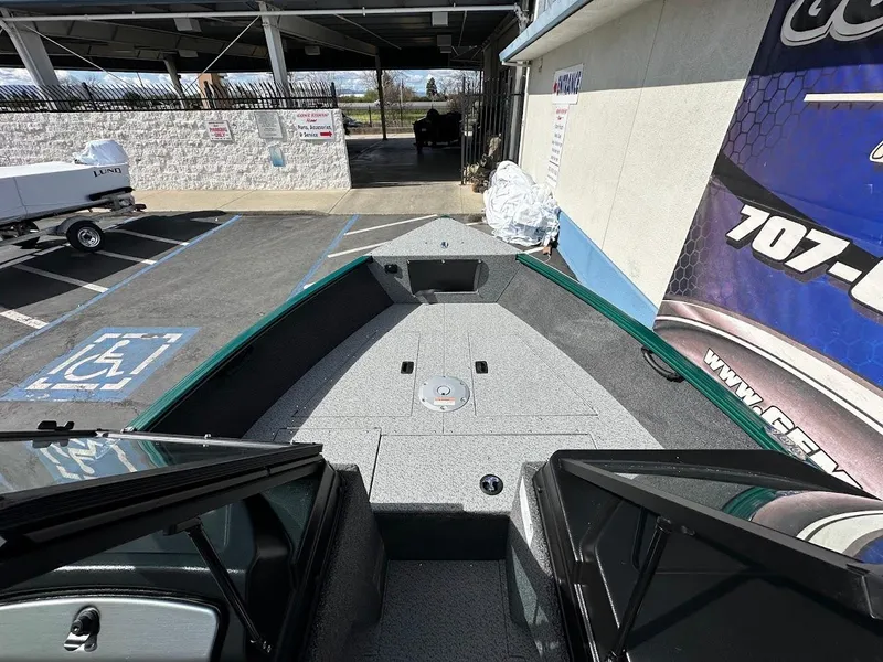 Slide: The Image of 2025 Lund 1650 Rebel XL Sport boat, interior view, parked in a lot. - 18