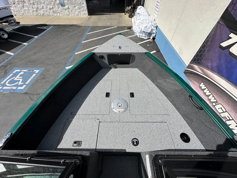 Slide: The Image of 2025 Lund 1650 Rebel XL Sport boat deck, featuring spacious storage and seating area. - 19