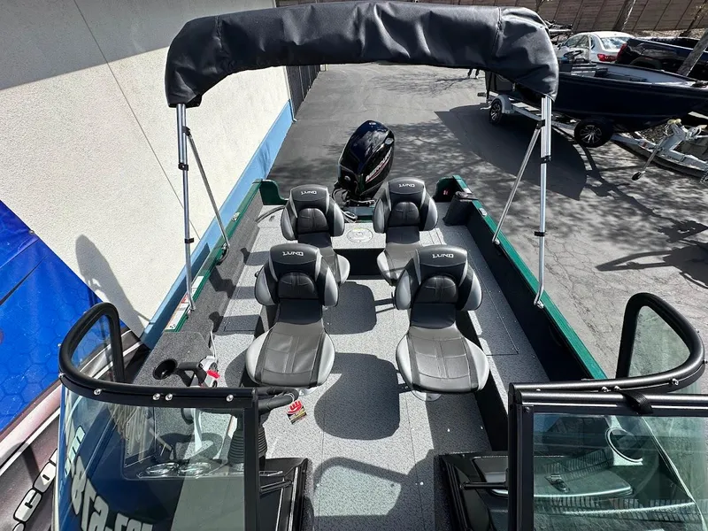 Slide: The Image of 2025 Lund 1650 Rebel XL Sport boat interior with seating and canopy. - 21