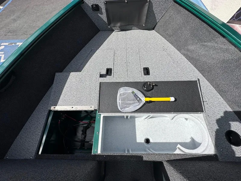 Slide: The Image of 2025 Lund 1650 Rebel XL Sport boat interior with fishing net and storage compartments. - 22