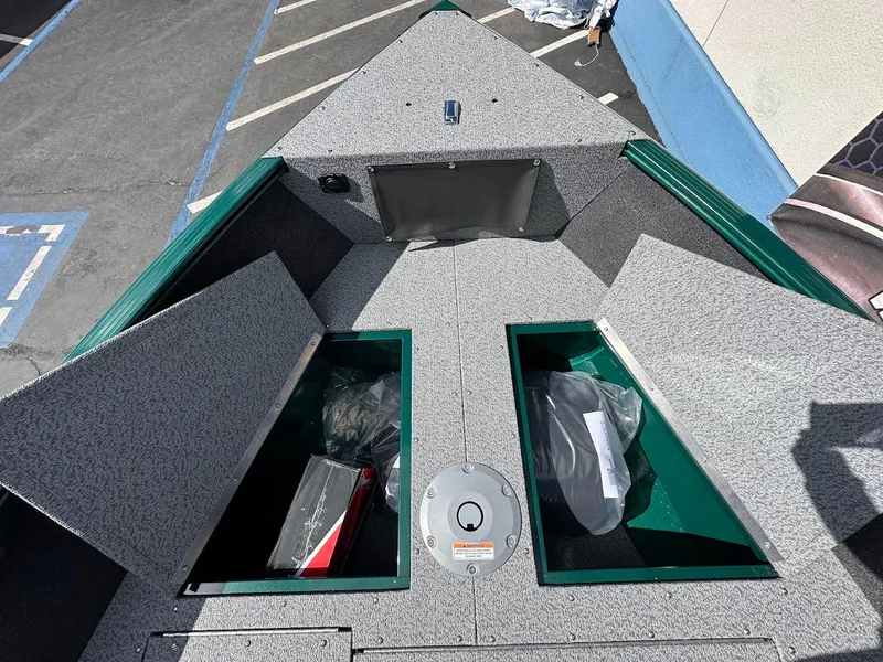 Slide: The Image of 2025 Lund 1650 Rebel XL Sport boat interior with open storage compartments. - 23