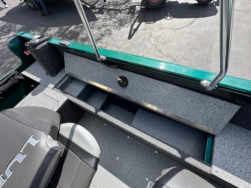 Slide: The Image of 2025 Lund 1650 Rebel XL Sport boat interior with seating and storage compartments. - 24