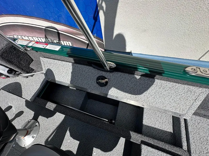 Slide: The Image of 2025 Lund 1650 Rebel XL Sport boat interior with storage compartments and seating. - 26