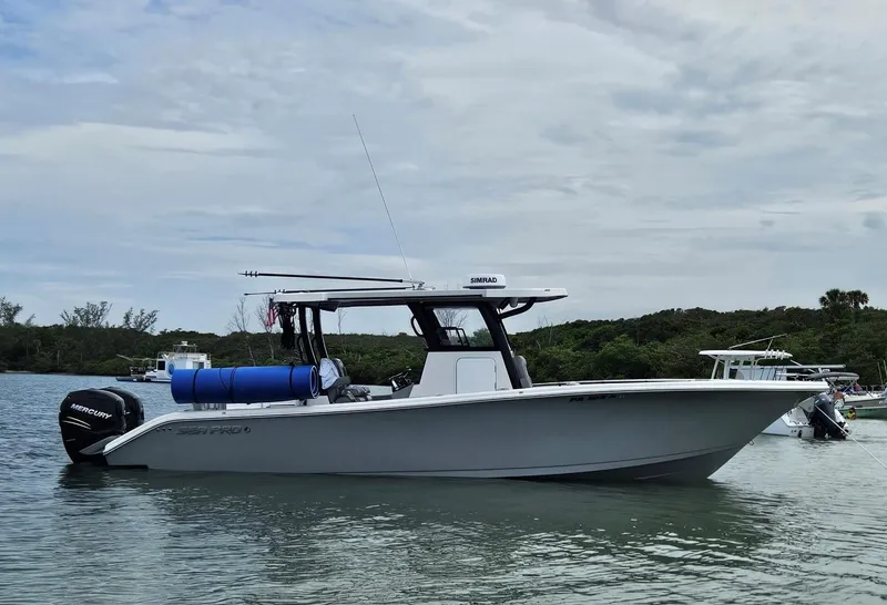 Slide: The Image of 2023 Sea Pro 320 DLX Center Console boat on calm water, with Mercury engines. - 34