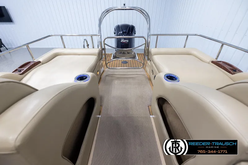 Slide: The Image of 2014 SunCatcher Elite 324 boat interior with seating and motor, Reeder-Trausch Marine logo. - 15