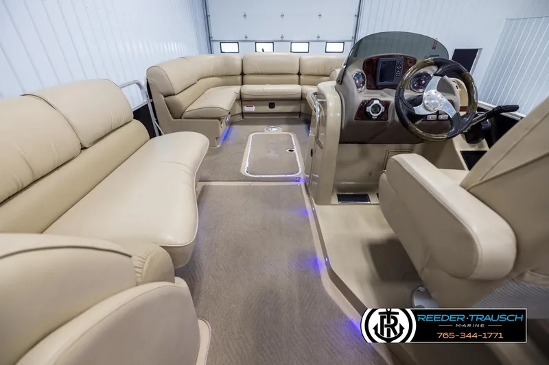Slide: The Image of Interior of 2014 SunCatcher Elite 324 pontoon boat with beige seating and modern dashboard. - 17