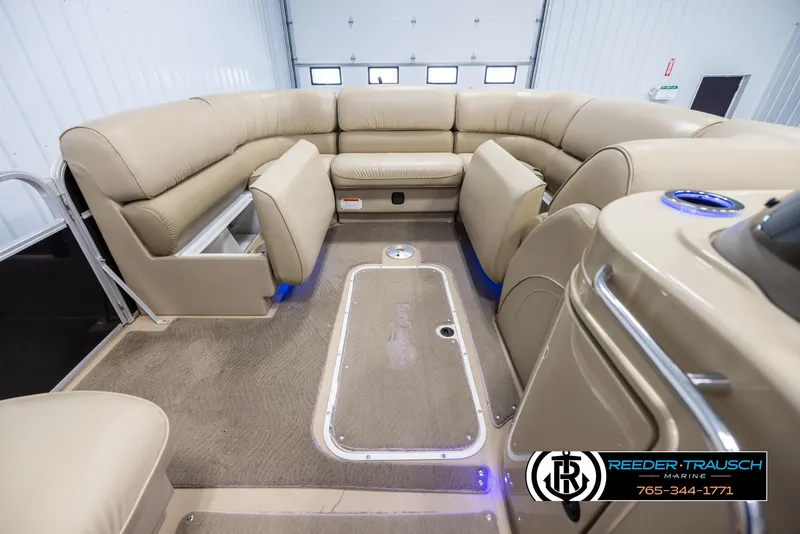 Slide: The Image of 2014 SunCatcher Elite 324 interior with beige seating and spacious layout. - 19