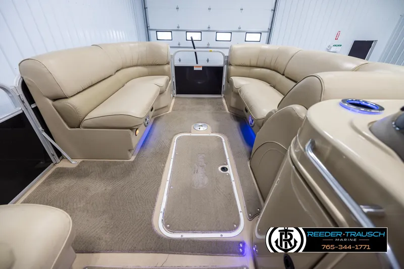 Slide: The Image of Interior of 2014 SunCatcher Elite 324 pontoon boat with beige seating and blue accent lighting. - 20