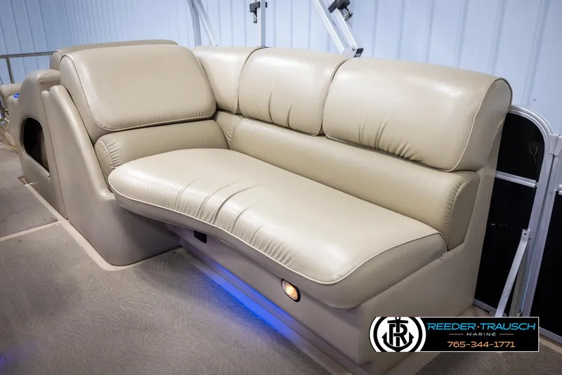 Slide: The Image of 2014 SunCatcher Elite 324 boat interior with beige leather seating and ambient lighting. - 21