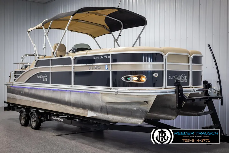 Slide: The Image of 2014 SunCatcher Elite 324 pontoon boat on trailer in indoor showroom. - 3