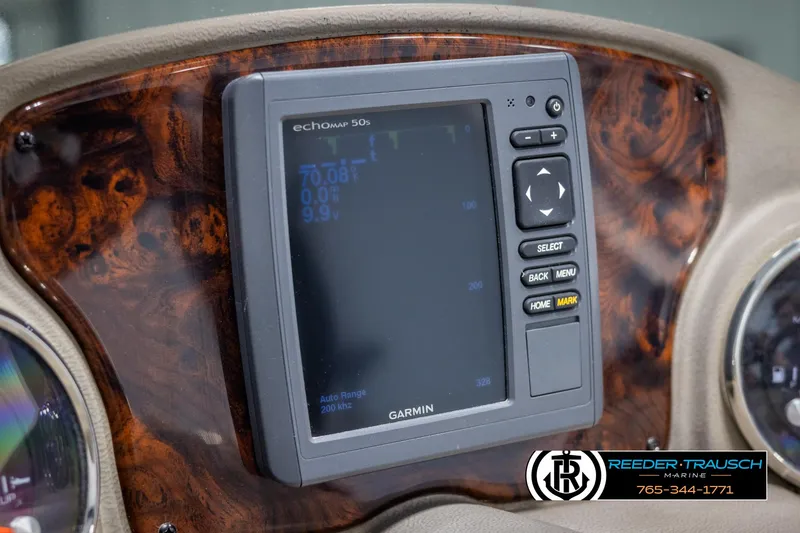 Slide: The Image of Garmin EchoMap 50s on 2014 SunCatcher Elite 324 dashboard, wood grain finish. - 30