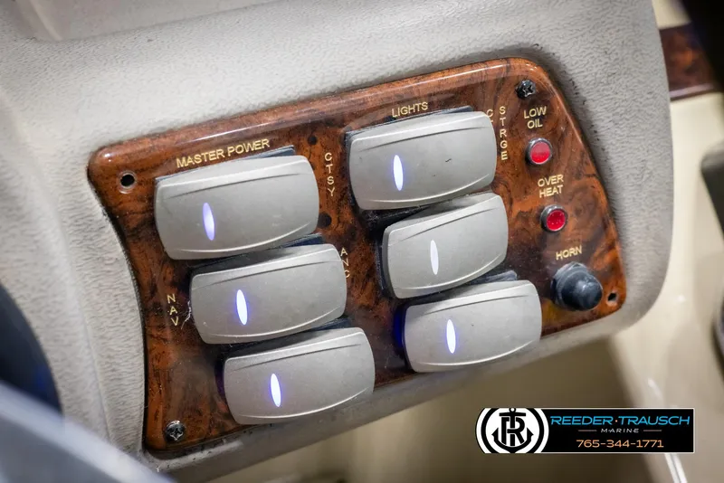 Slide: The Image of Control panel of a 2014 SunCatcher Elite 324 boat with labeled switches and indicators. - 33