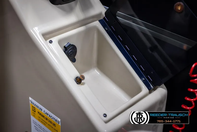 Slide: The Image of 2014 SunCatcher Elite 324 storage compartment with power outlet and capacity label. - 35