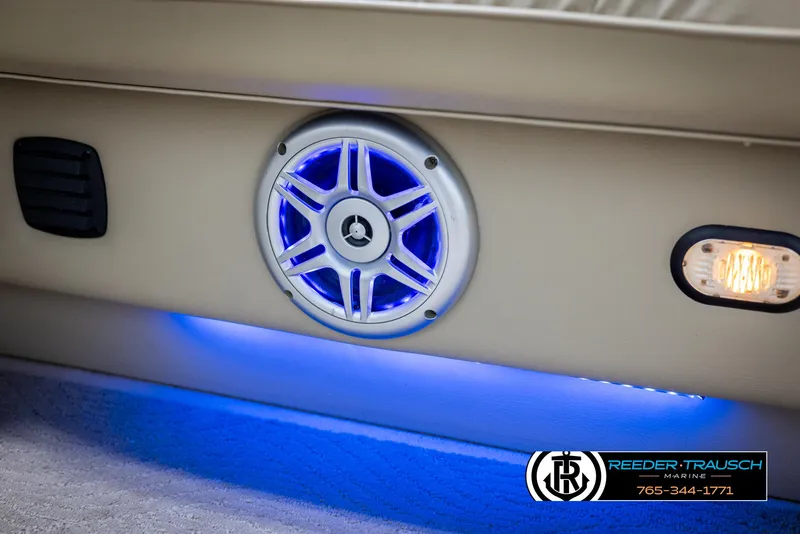 Slide: The Image of 2014 SunCatcher Elite 324 boat speaker with blue LED lighting and branding. - 38
