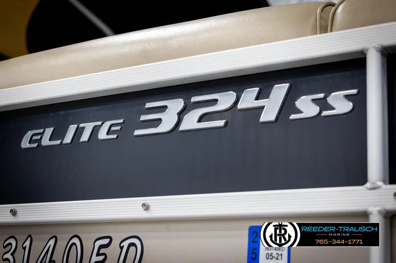 Slide: The Image of 2014 SunCatcher Elite 324 boat model nameplate with dealership logo. - 49