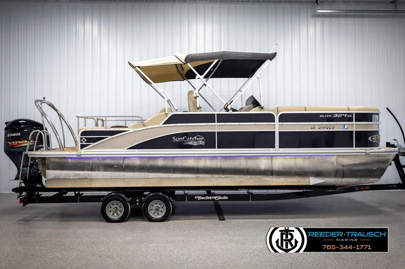 Slide: The Image of 2014 SunCatcher Elite 324 pontoon boat on trailer in indoor showroom. - 5