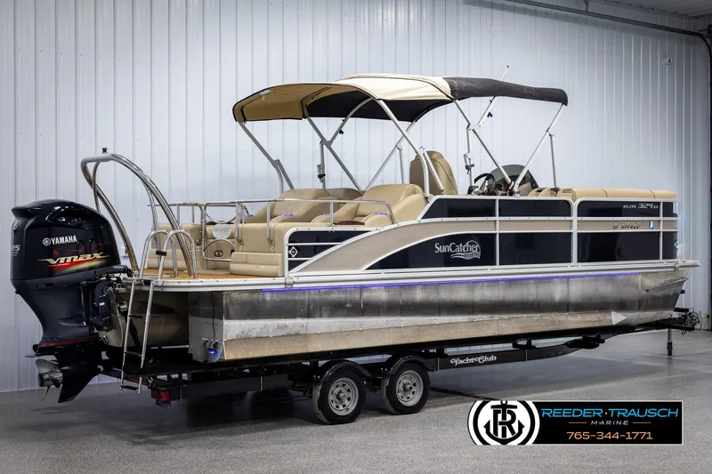 Slide: The Image of 2014 SunCatcher Elite 324 pontoon boat on trailer in indoor storage. - 6