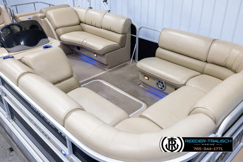 Slide: The Image of 2014 SunCatcher Elite 324 pontoon boat with beige seating and blue accent lighting. - 9