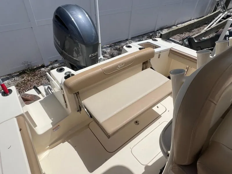Slide: The Image of 2022 Scout 215 XSF boat interior with seating and outboard motor. - 6