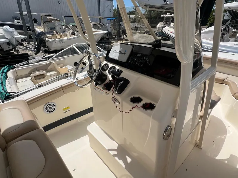 Slide: The Image of 2022 Scout 215 XSF boat interior with steering wheel and Garmin navigation system. - 8