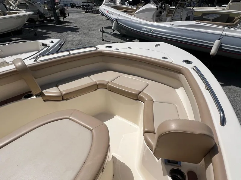 Slide: The Image of 2022 Scout 215 XSF boat interior with beige seating and sleek design. - 9